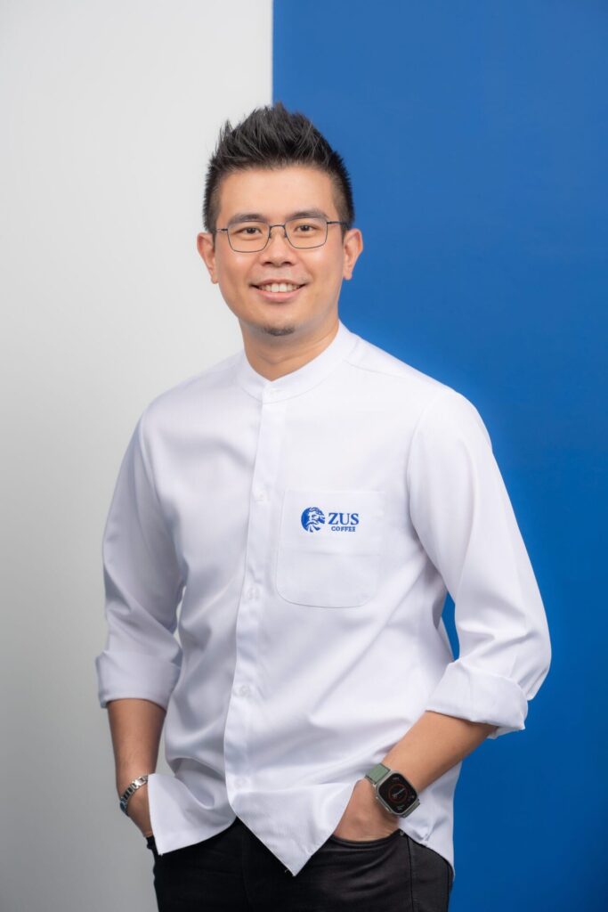 Venon Tian in a white branded shirt against a clean blue and white studio background.