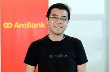 Keong Chun Chieh in a black shirt standing indoors with a branded background