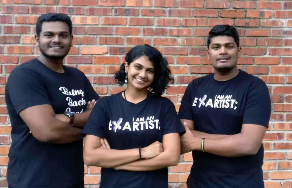 Eswaran Mohan, Renuga Nair & Arun Mohan in black T-shirts standing with folded arms