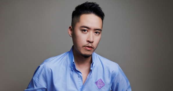 Bryan Loo in a blue shirt against a clean studio background.