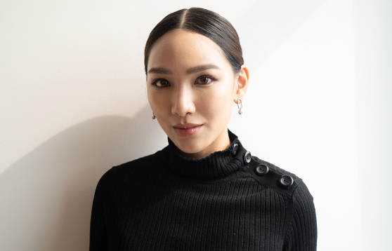 Jane Chuck in a black ribbed top with button-detail shoulders