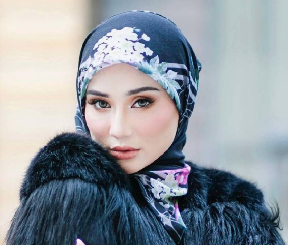 wawa zainal wearing a patterned hijab and a black faux fur wrap